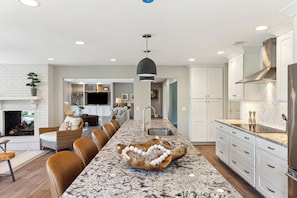 Enjoy cooking in this well-equipped kitchen with a central island, stainless steel appliances, and granite countertop.