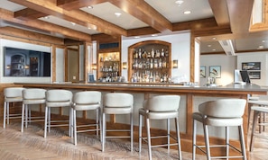 Enjoy a drink at the hotel's bar, where a long countertop and cushioned stools await.