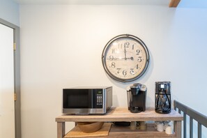 A kitchen area with a microwave, coffee maker, and a clock on the wall. - 2BR/2BA Condo in Historic Telluride. (Telluride)