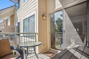 Enjoy a peaceful retreat with a balcony offering a glass table and two chairs.
