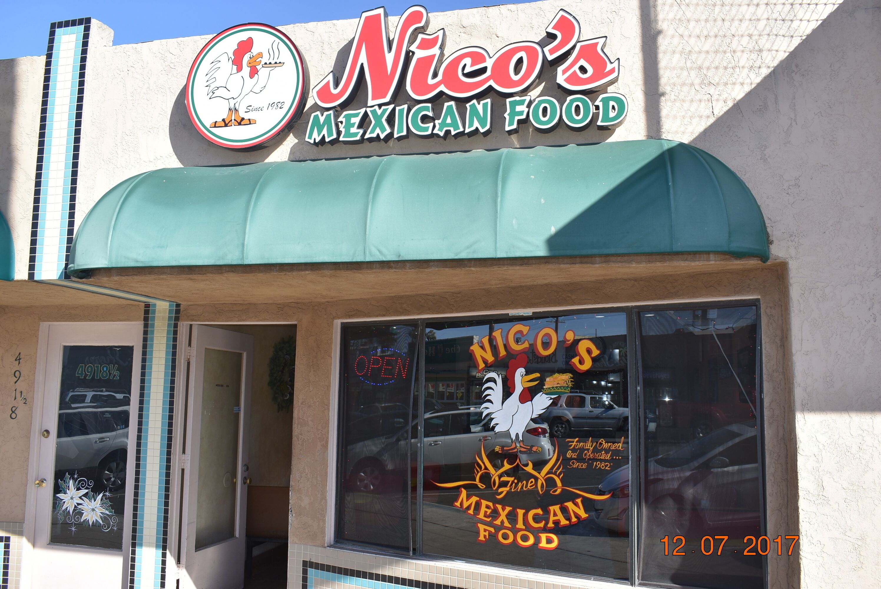 A restaurant named Nico's Mexican Food with a green awning and a rooster logo.