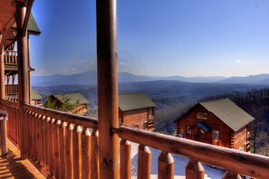 Enjoy breathtaking views of the mountains from the cabin's balcony.