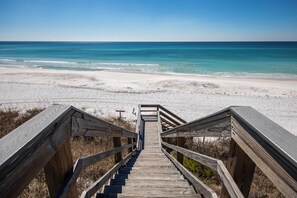 A wooden staircase leading to a beach with clear blue water. - Villas at Santa Rosa #A102 - Location, location, location. (Santa Rosa Beach)