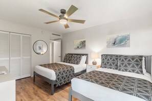 A bedroom with two beds, a ceiling fan, and artwork on the walls. - Exquisite Escape: Elegantly Renovated Wailea Elua 801 – Tranquil Paradise (Wailea, Maui)