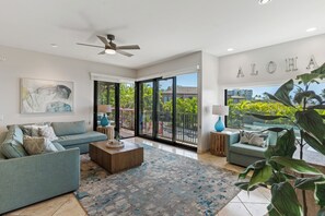 Un moderno salón con sofá, una mesa de centro y vistas al exterior.
