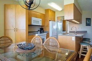 Enjoy a convenient kitchen with microwave, stainless steel refrigerator, and sink with modern faucet.