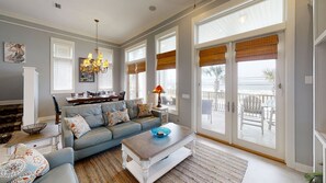 Relax in this stylish living room with a comfortable sofa, coffee table, and dining area.
