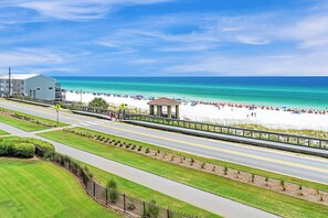 A coastal road with a beach and a gazebo.