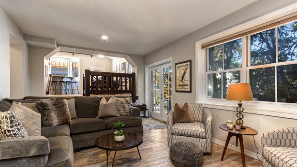 A spacious living room with a large window, a fireplace, and a cozy seating area. - Epic Home Just Steps to Main Street + Hot tub (Park City)