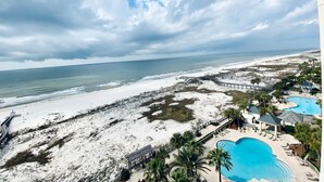 A resort with a large pool, beach access, and a view of the ocean. - Beach Club 1004B by ALBVR - Beachfront Beauty - New appliances and bunk beds (Gulf Shores)