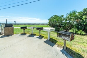 Enjoy al fresco dining and scenic views from this outdoor area with barbecue grills and a grassy landscape.