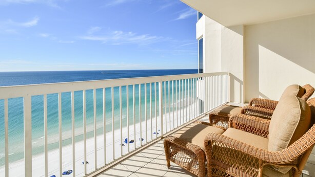 A balcony with wicker furniture and a view of the ocean. - Serene Modern Beachfront Condo w/ Easy Beach Access at Silver Beach Towers! 🌊☀ (Destin)
