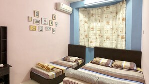 A bedroom with two beds, a ceiling fan, an air conditioner, and a wall with framed pictures. - Sakura 2 Homestay Kampar (Kampar)