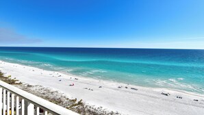 A beach with clear turquoise waters and a white sandy shore.