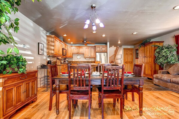 Enjoy dining and relaxation in this inviting space with a dining table, comfortable seating, and a cozy couch.