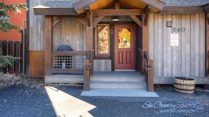A wooden building with a red door and a sign indicating high alpine conditions. - Downtown Gem - Ski Resort Views, Private Hot Tub, Dog-Friendly MainD (Breckenridge)