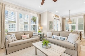 A living room with two sofas, a coffee table, and a chandelier. - TipSea Kitty - 3BR/2.5BA Prominence Home - Sleeps 8 - 6-Seat LSV & Community Pool (Rosemary Beach)