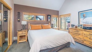A bedroom with a large bed, wooden nightstands, a dresser, and a mirror. - Spacious Condo in Telluride-Beautiful West Views! (Telluride)