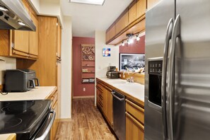 A modern kitchen with stainless steel appliances, wooden cabinets, and a built-in dishwasher. - Lulu City #4C Fresh Mountain Style Steps to Coonskin Lift Sleeps 7 (Telluride)