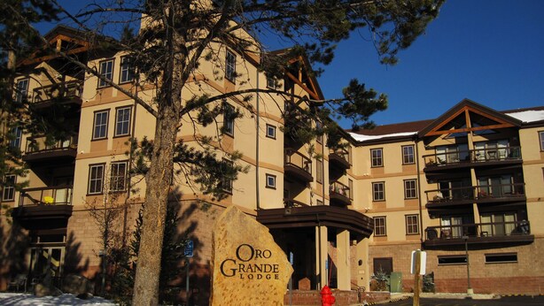 A multi-story building with a sign reading "Oro Grande Lodge." - Pool, Hot Tub, Elevator, Gym! Walk to River Trail, Festivals, Dining, Shops (Keystone)