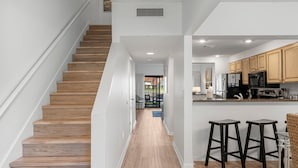 A modern kitchen with wooden cabinets, a stainless steel refrigerator, and a built-in oven. - Lake Views ~ Golf Cart ~ Community Pool (Miramar Beach)