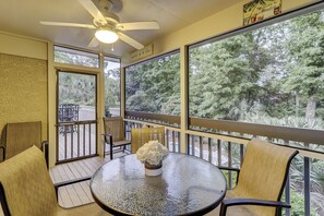 Sit comfortably around the round table, surrounded by lush forest views.