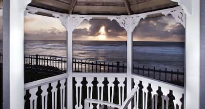 Surf, sand, kites, wave jumping are magical from this large beachfront home.