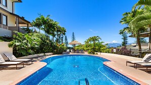 A swimming pool with lounge chairs and palm trees. - Celebrated Villa, stylish and stunning golf views (Lahaina)
