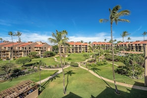 A resort with multiple buildings, palm trees, and well-maintained lawns.