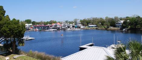 A marina with boats docked, a marina building, and a small dock.