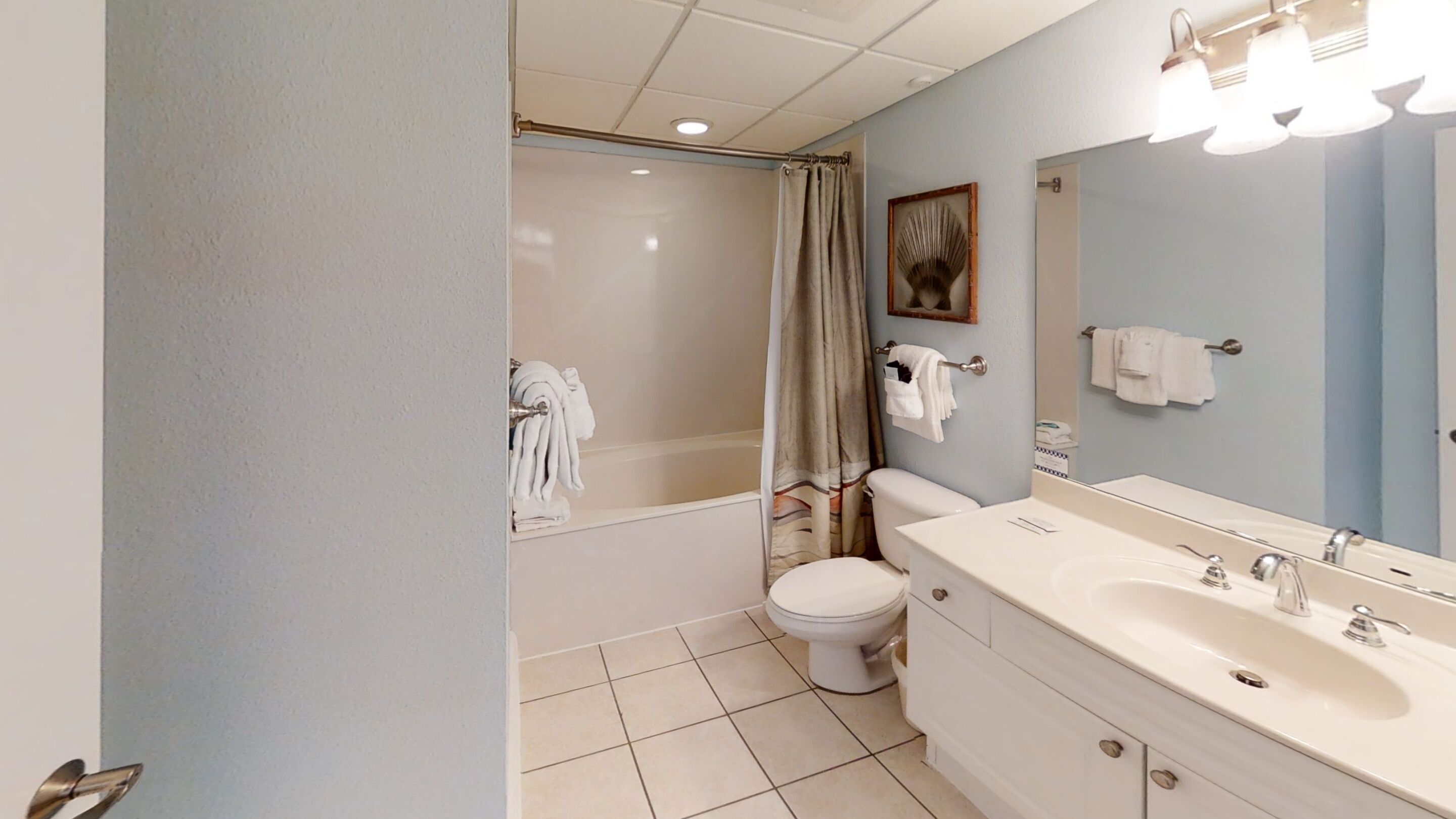 A bathroom with a bathtub, toilet, and sink.