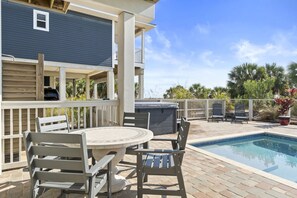 Step onto your private deck where outdoor dining meets poolside bliss, complete with hot tub and tropical palm views. - Pelican Palms: 4 BR IP Beachfront Home- Sleeps 14, Pet Friendly, Priv. Pool! (Port St. Joe)