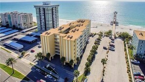 A coastal hotel with multiple floors, a parking area, and a beach view. - Heated Pool/Spa - Beachside! , Sleeps 10, Balcony 101 (Redington Shores)