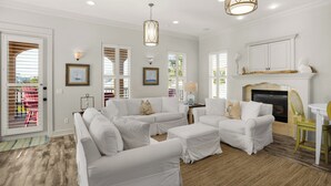 A spacious living room with white furniture, a fireplace, and large windows with shutters. - Private Pool & Beach Access + Free Tickets: Bikes, Dolphin Cruise & More! (Seacrest)