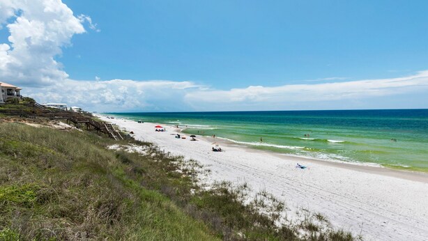 A beach with a wooden staircase leading to a building, a sandy shore, and the ocean. - Private Pool & Beach Access + Free Tickets: Bikes, Dolphin Cruise & More! (Seacrest)