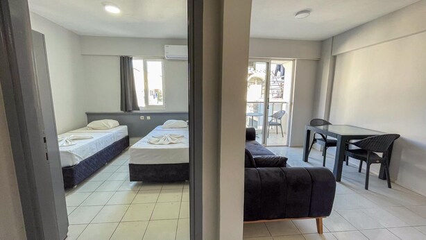 Une chambre d’hôtel avec deux lits, une table à manger et un canapé.