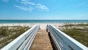 A wooden boardwalk leading to a beach with white railings. - Endless Summer by GSVR | 7BR Beachfront Home w/ Pool & Handicap Access + FREE Activities/Golf (Gulf Shores)