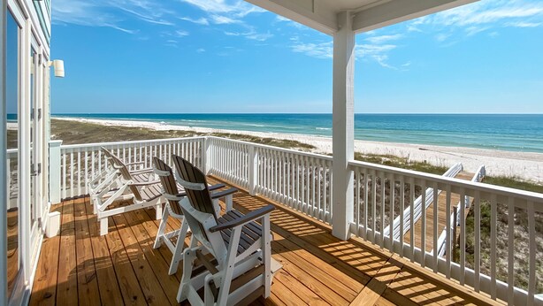 A wooden deck with white railings overlooking a beach. - Endless Summer by GSVR | 7BR Beachfront Home w/ Pool & Handicap Access + FREE Activities/Golf (Gulf Shores)
