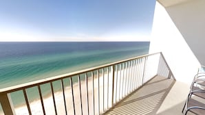 A balcony with a view of the ocean.