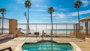 A swimming pool with a view of the beach and ocean. - Panoramic Ocean View White Sandy Beaches   Community Jacuzzi (Oceanside)