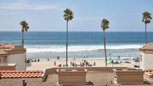 A beach view with palm trees, a sandy beach, and a clear blue sky. - Panoramic Ocean View White Sandy Beaches   Community Jacuzzi (Oceanside)
