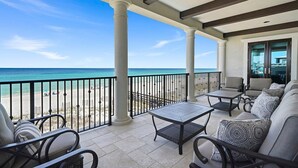 A covered outdoor seating area with a view of the beach and ocean. - Verona - Huge Ocean Front Home in Gulf Pines with Private Pool & Beach Access (Miramar Beach)