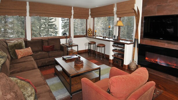 A living room with a sofa, armchair, coffee table, and a fireplace. - Perfect Views and Location in Lionshead! Well Appointed Condo Steps from Lifts (Vail)