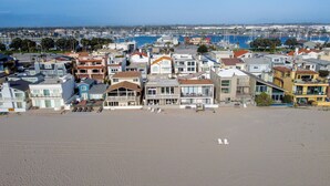 A coastal residential area with beachfront properties, including houses with balconies and beachside views. - 3441O Mollies by the Sea (Oxnard)