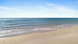 A beach with clear skies and calm waters. - Regency Isle 911 by Liquid Life (Orange Beach)