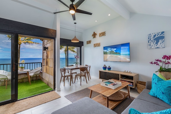 Relax on the balcony with ocean views, enjoy meals at the dining table, and unwind in the seating area with a sofa and flat-screen TV.