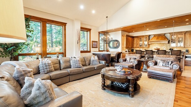 A spacious living room with a large sectional sofa, a coffee table, and a fireplace. - Pristine Mountain Home. Perfect for Families - Hot Tub, Media Room & Elevator (Park City)
