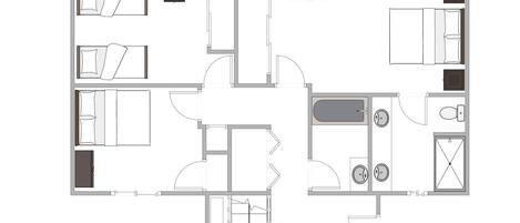 A floor plan of a hotel room with a bathroom, a kitchenette, and a seating area.