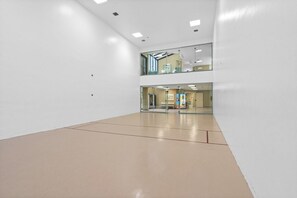 A spacious, well-lit indoor area with a high ceiling and a polished floor.