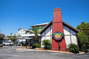 A building with a prominent sign for Stinky's Fish Camp, featuring a fish logo and the name.